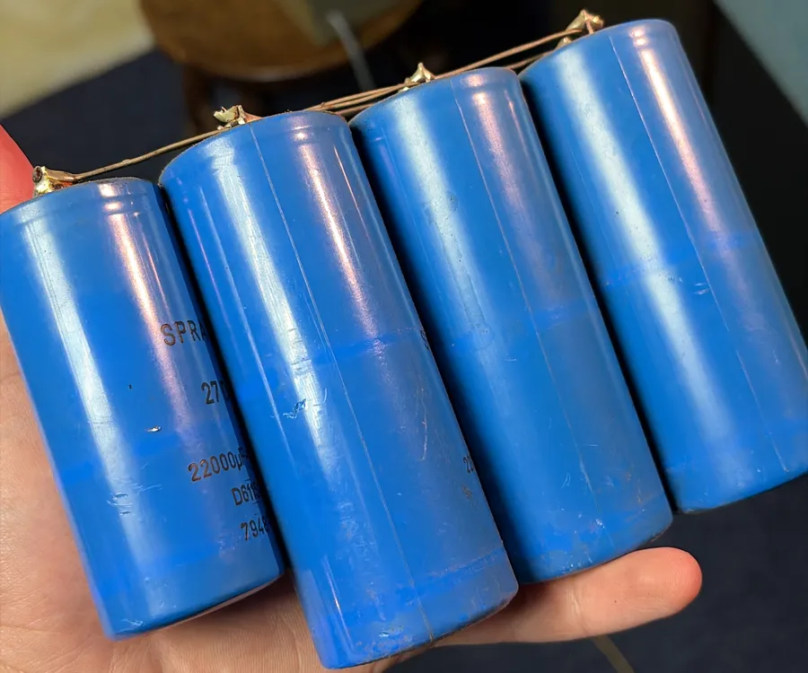 Four large blue Sprague filter capacitors wired together, held in my hand