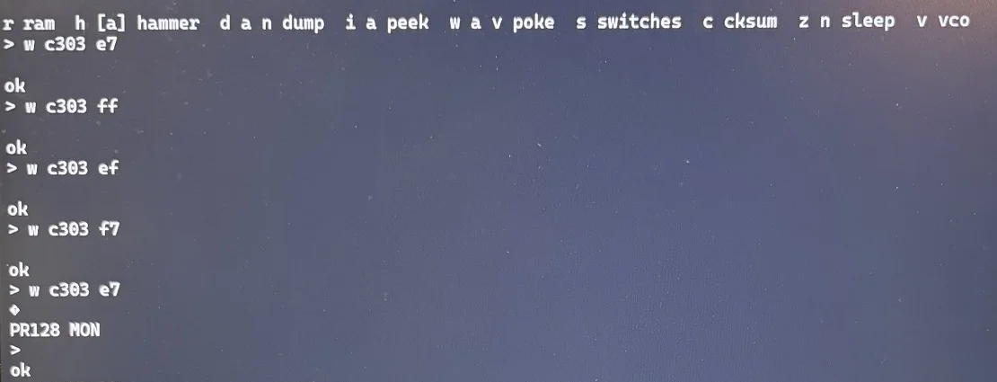Terminal on my laptop connected to the debug ROM, showing its list of commands and a series of w c303 commands writing different values to address C303, each answered with ok, until the board resets and prints its PR128 MON banner again